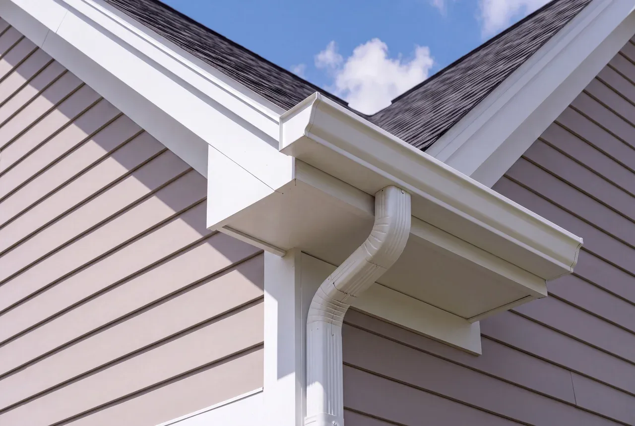 Close view of a new seamless K-style gutter, mitre and downspout outlet